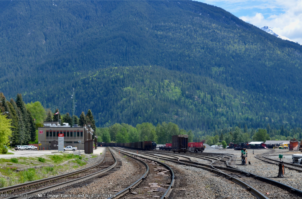 Looking east at the CP Rail Revelstoke office and Yard. The right lower part of this photograph shows part of the snow plow/spreader storage area and to the right upper, is Mt. MacKenzie of the Columbia Mountain Range.